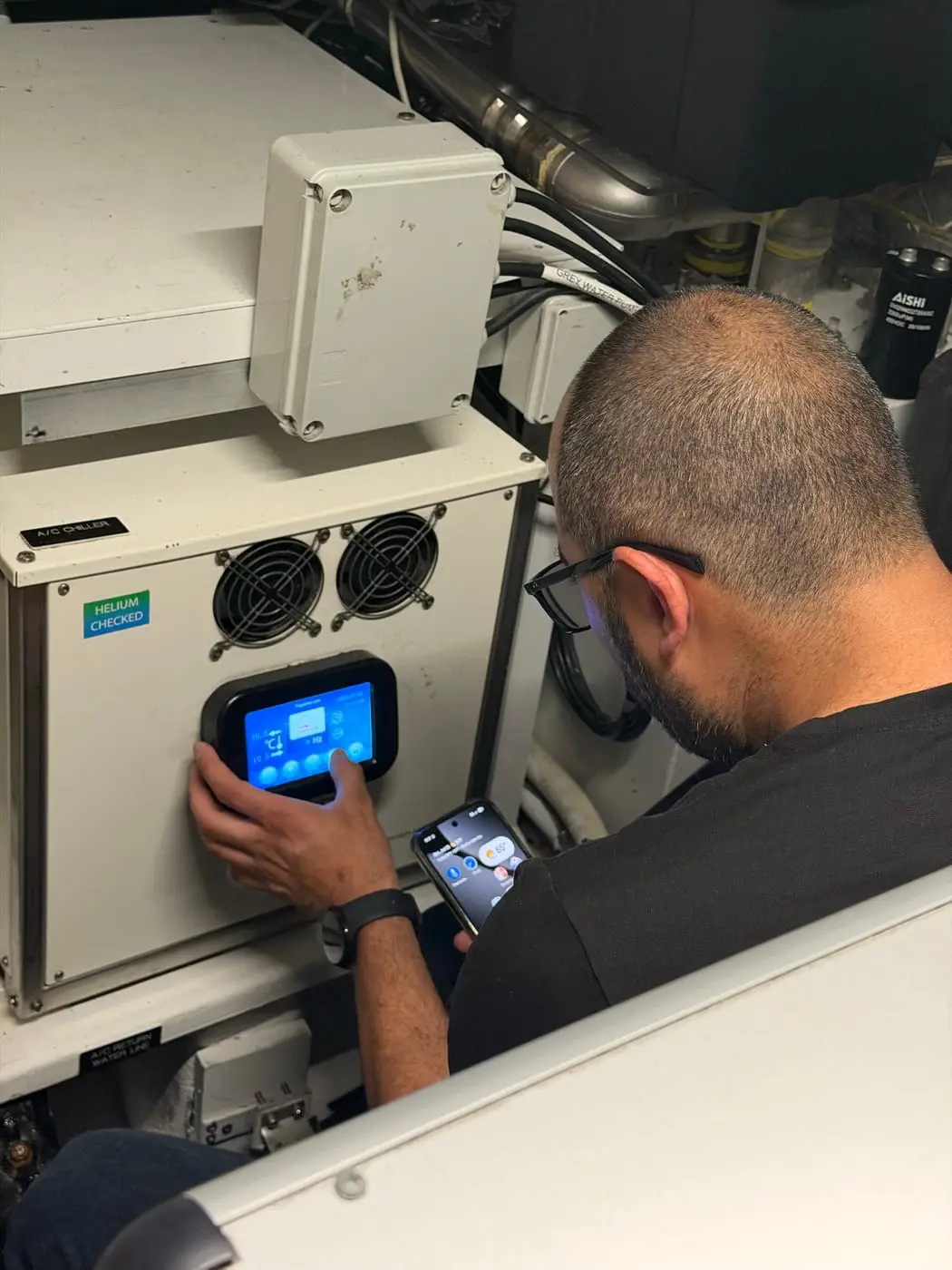 HOSS Marine technician commissioning a control panel aboard a yacht